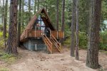 The cabin is perfectly nested in the woods.